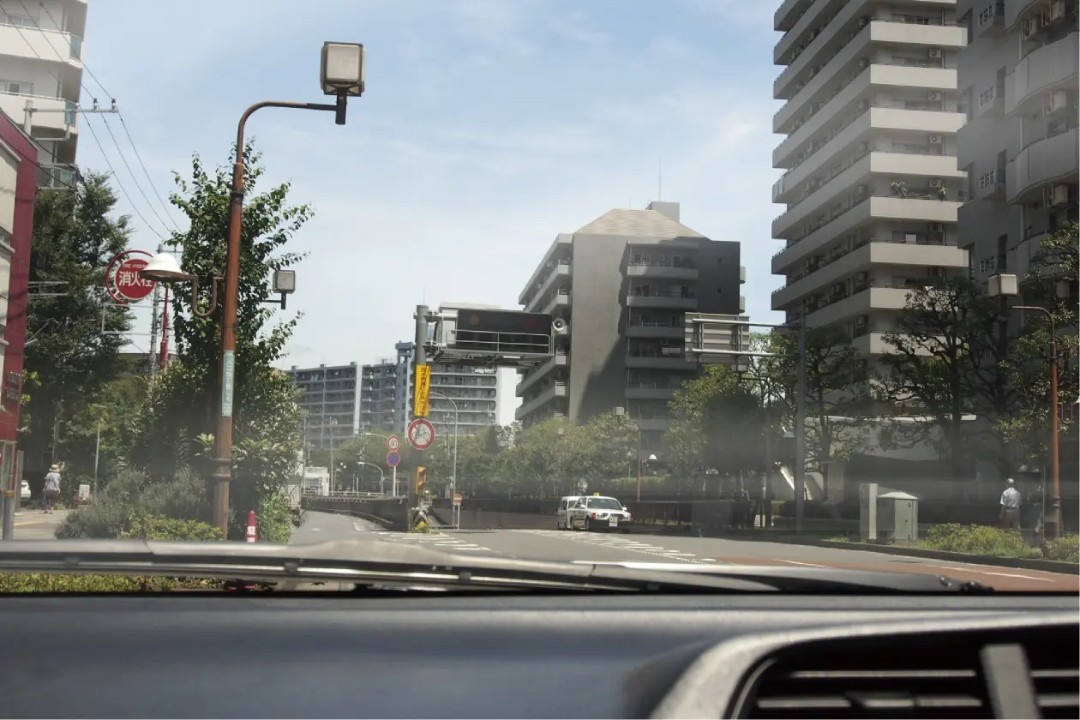 車のフロントガラスの反射で見えづらい街の風景